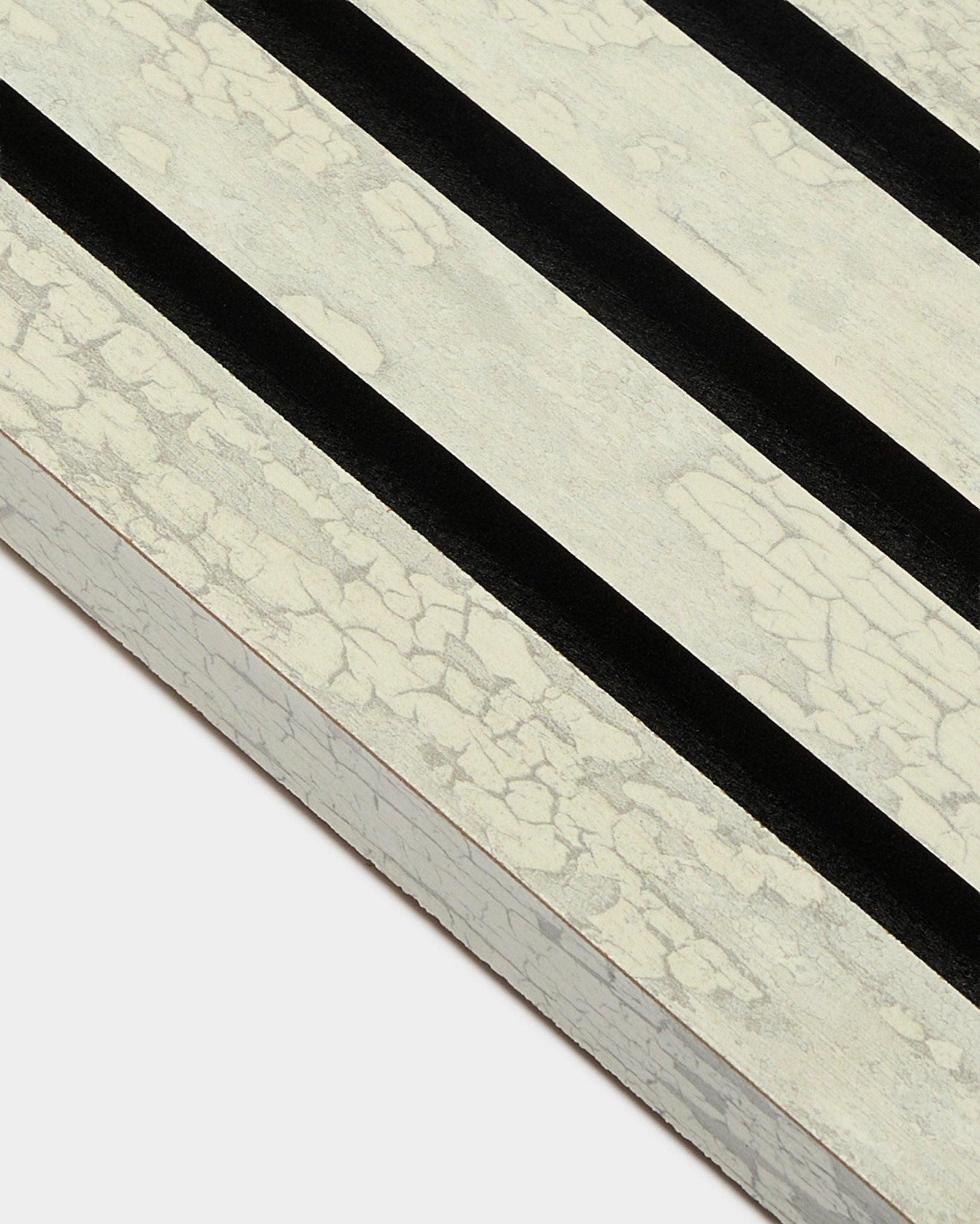 Primer plano de la lama final WoodUpp Akupanel en Oxide White (2,2 cm) con tres franjas diagonales black sobre un marco MDF Panel acústico.