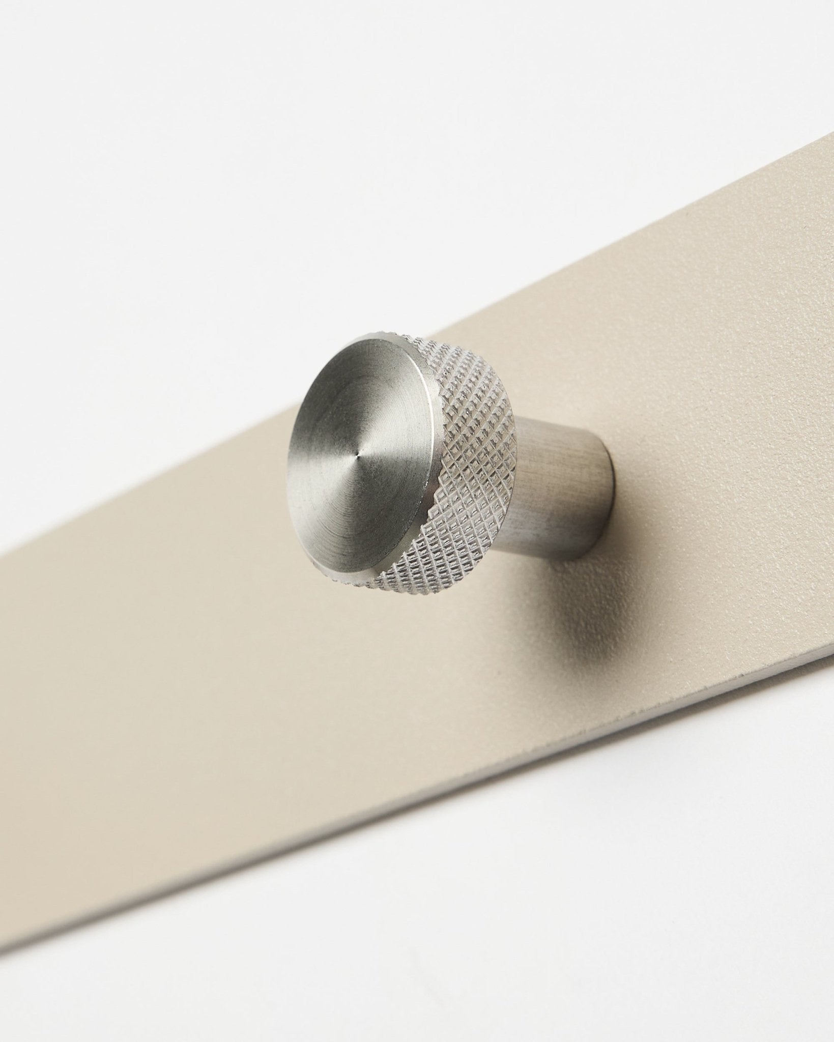 Primer plano del perchero de pared WoodUpp Norr en beige y acero inoxidable steel, X7, diseñado como accesorio para paneles acústicos de madera Akupanel o para organizar el recibidor.