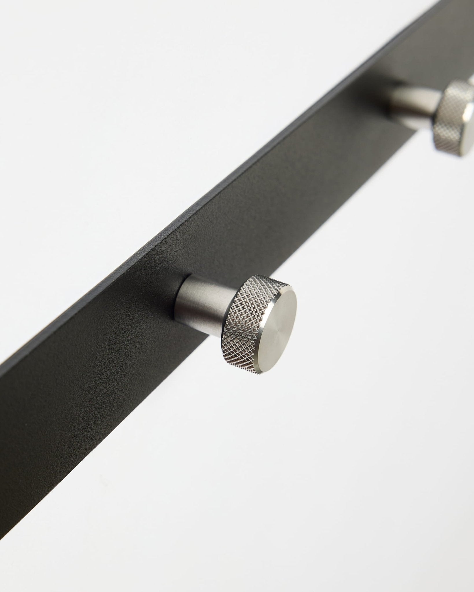 Primer plano de Norr | Coat Hook Rack / X5 de WoodUpp en black y acero inoxidable steel, diseñado como accesorio para paneles acústicos Akupanel o para usar en el recibidor.