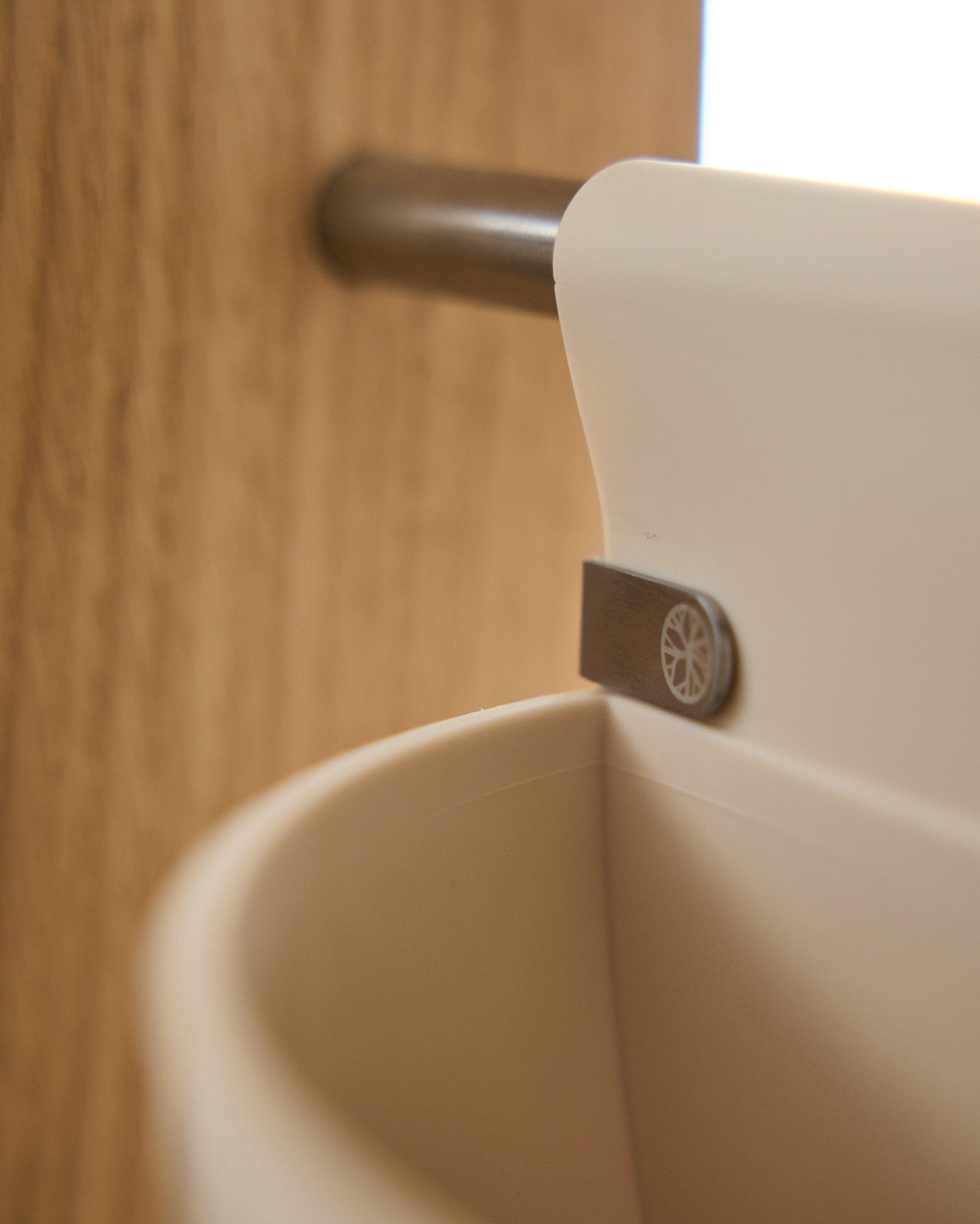 Primer plano de Gro | Soft Pocket / BM2 (4 l) en color claro beige de WoodUpp, colgado de una varilla metálica montada sobre madera; fondo desenfocado. Accesorio acústico nórdico.